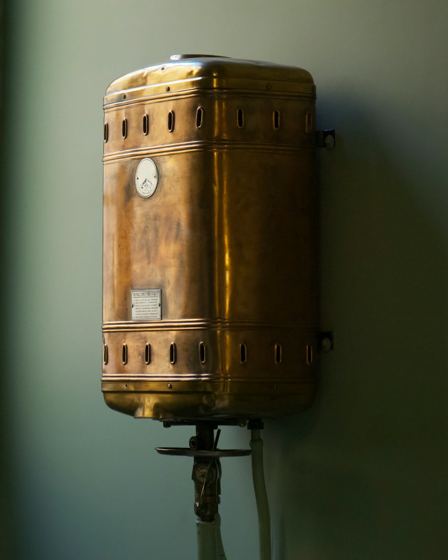 Copper water heater tank mounted on a wall